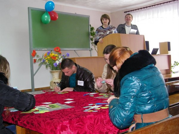 Учасники  гри з азартом рахують навчальні зразки готівки